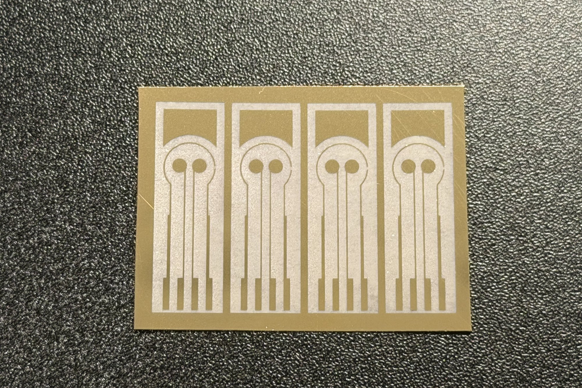Four electrode patterns raster-ablated in a gold film card
