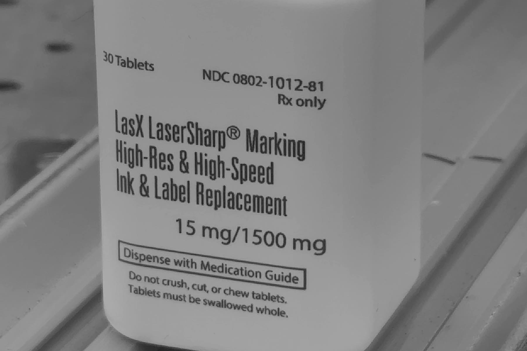 White HDPE bottle with a pharma-style demo label laser-marked directly on it: product name, dosage and Rx-only lines