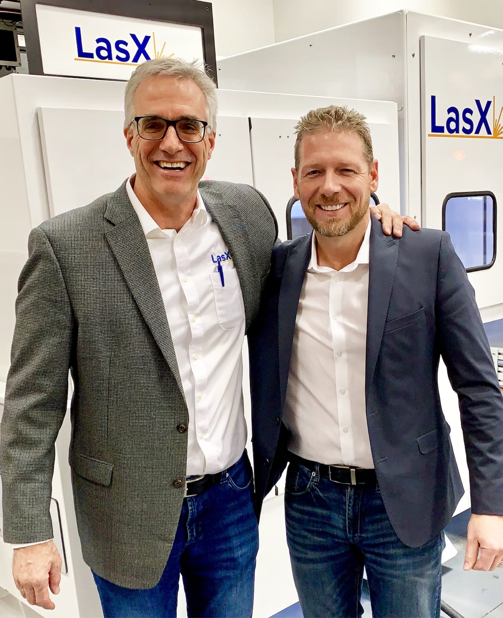 Two LasX team members beside LasX machines