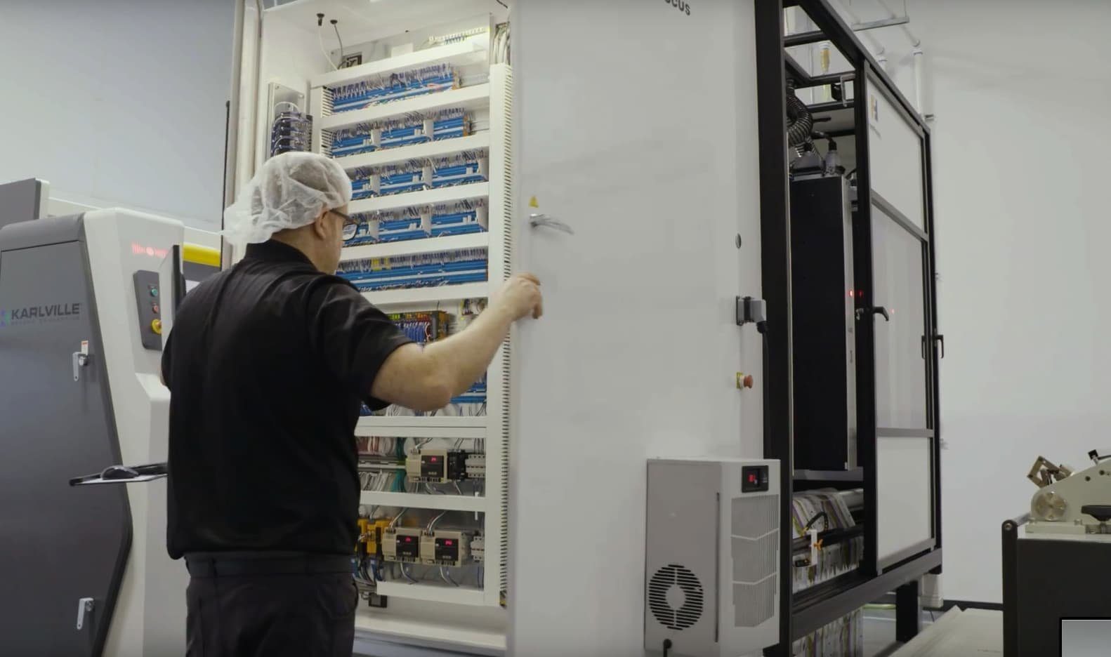 LasX technician wiring a machine control cabinet