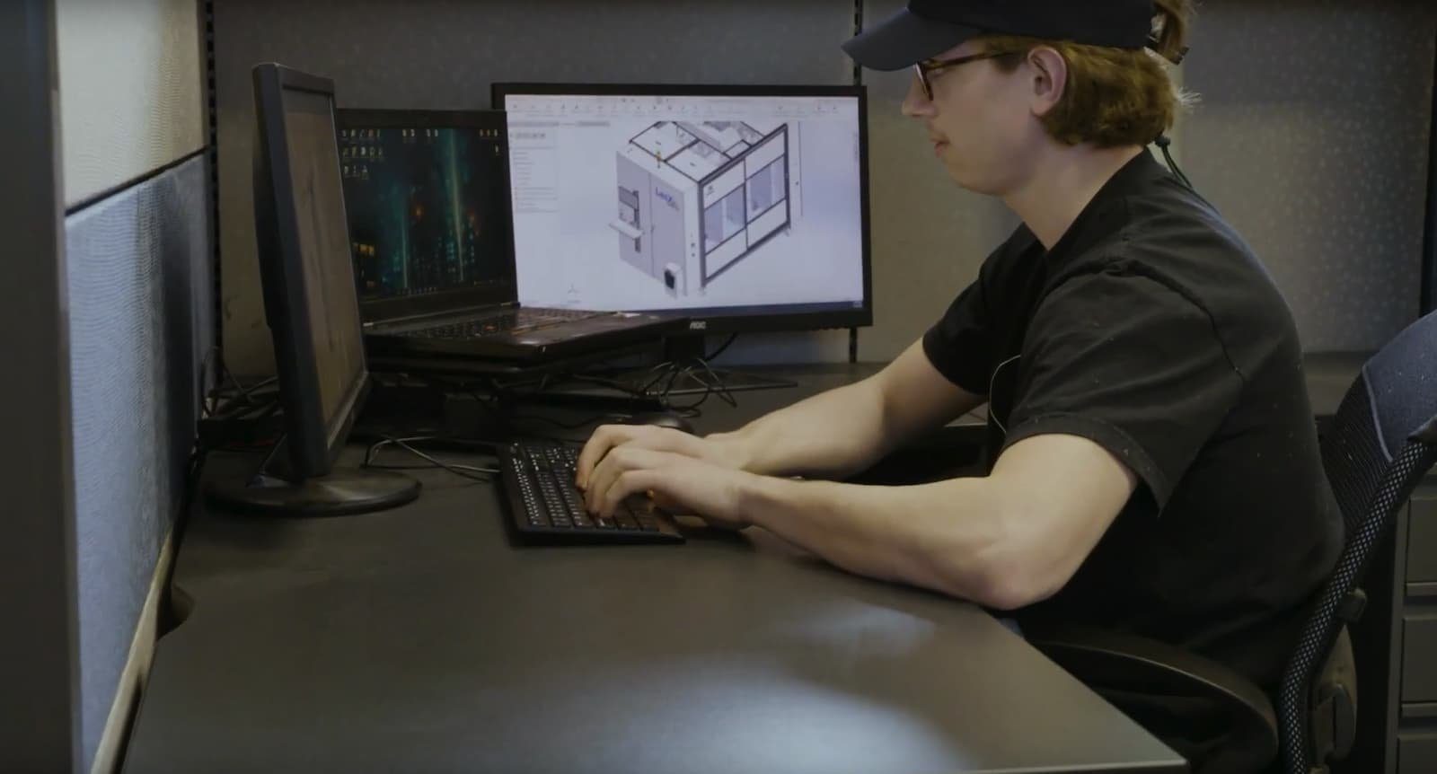 LasX engineer at a CAD workstation designing a machine