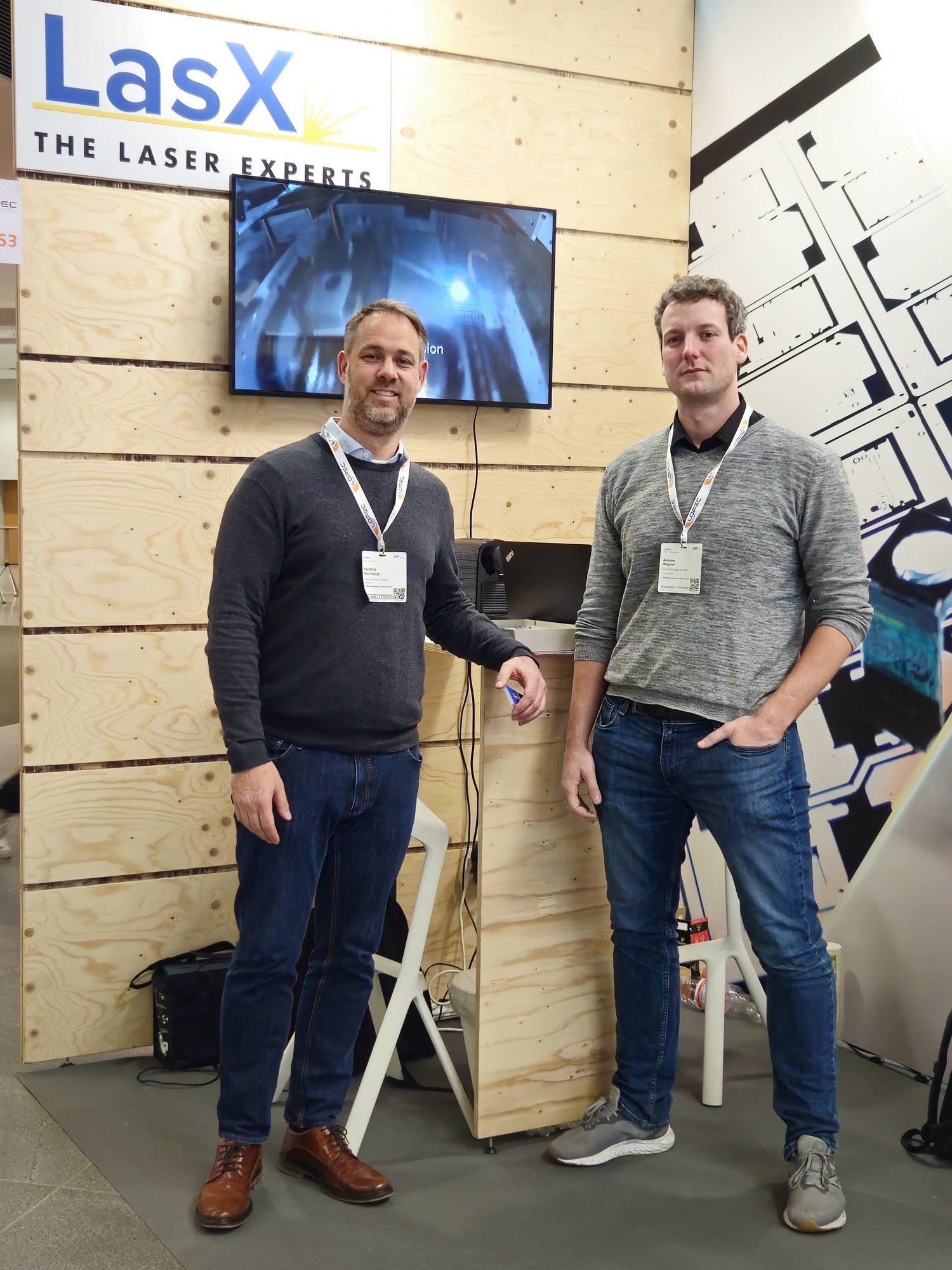 Two LasX team members at a trade-show booth