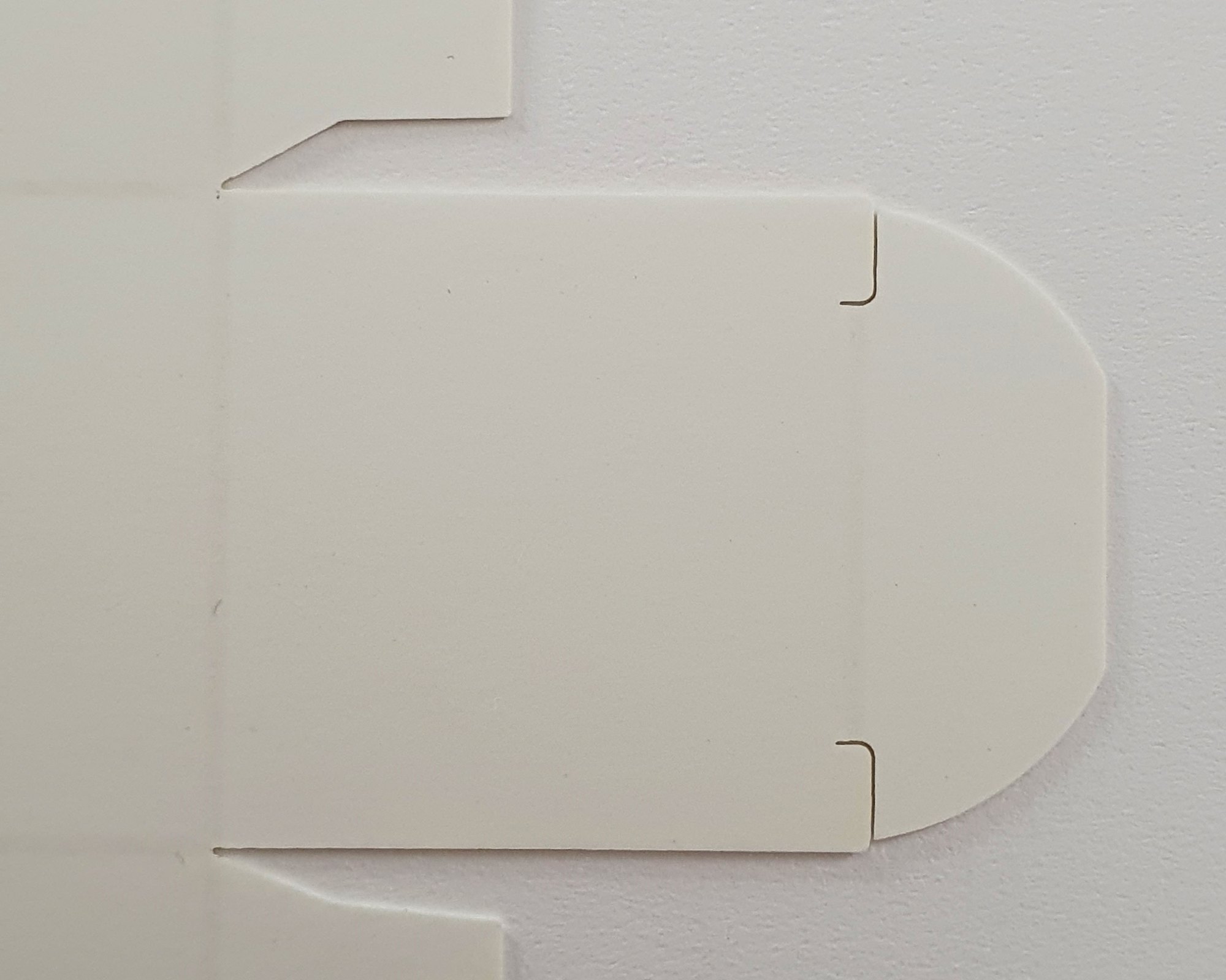 Outside face of the same white carton blank, fold lines faintly visible