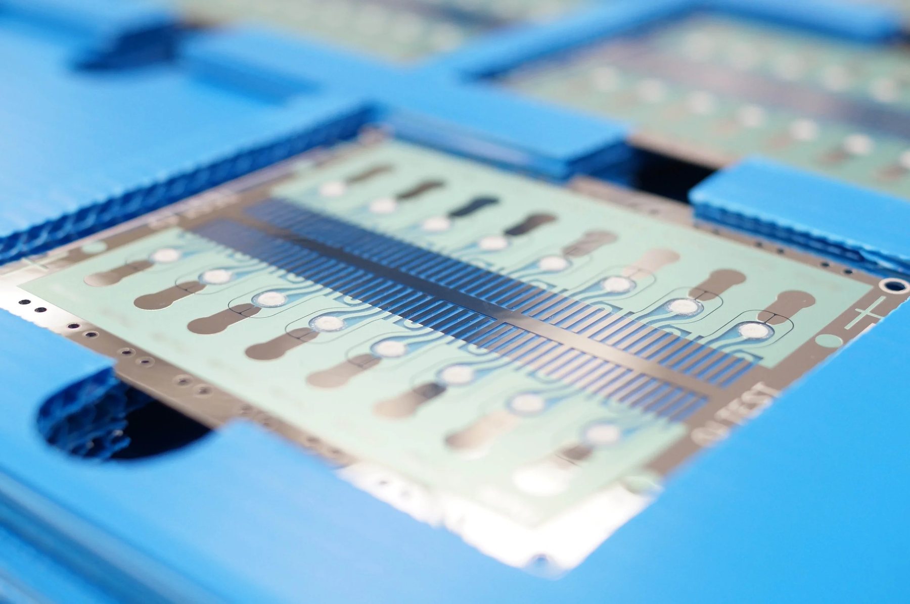 Biochip laminate with laser-micromachined channels and features