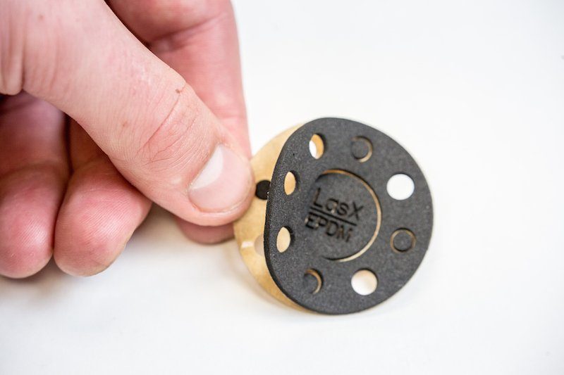 Hand holding a laser-cut EPDM gasket