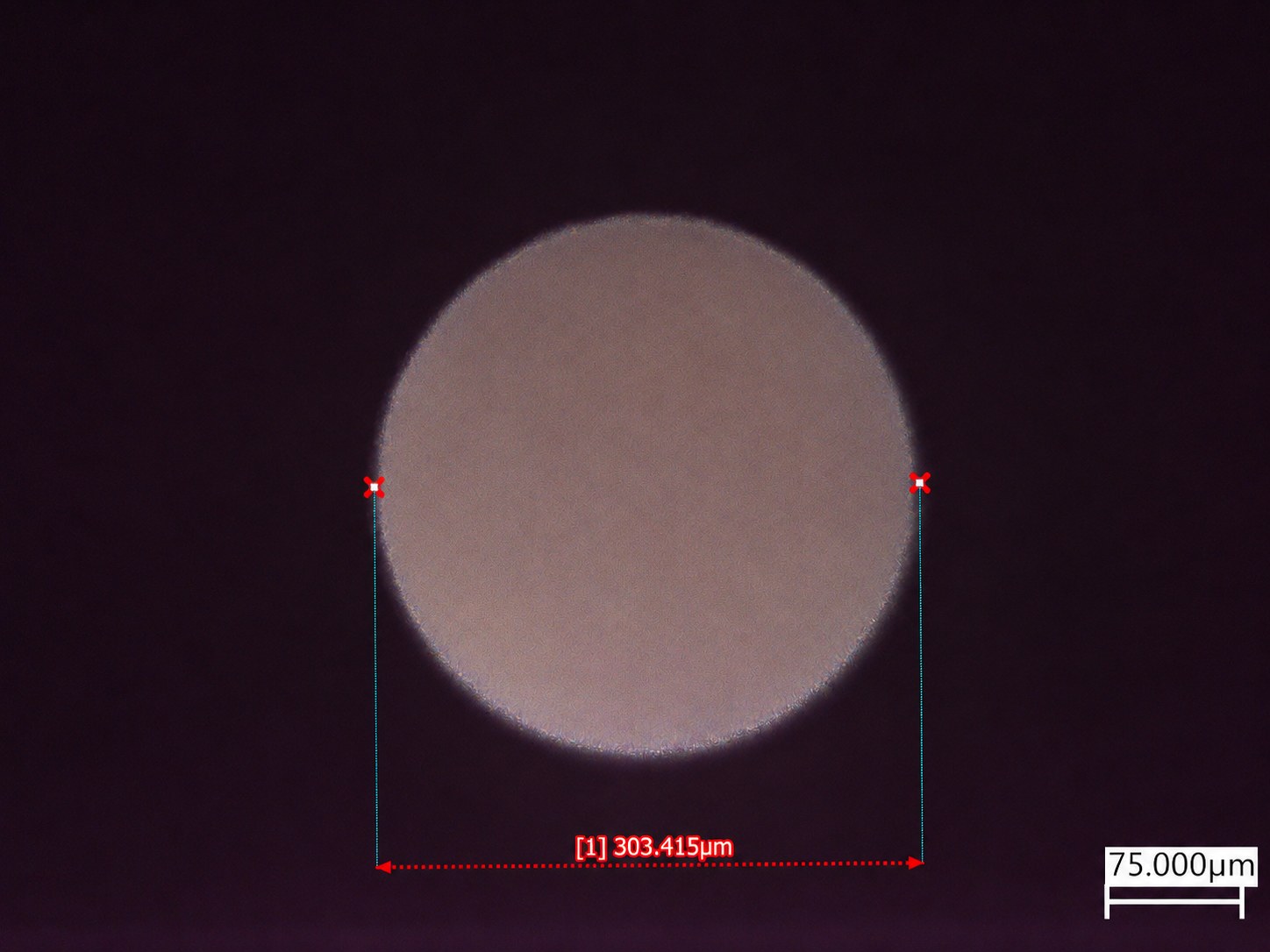 Single laser-drilled through-glass via in transmitted light, measured at 303 µm