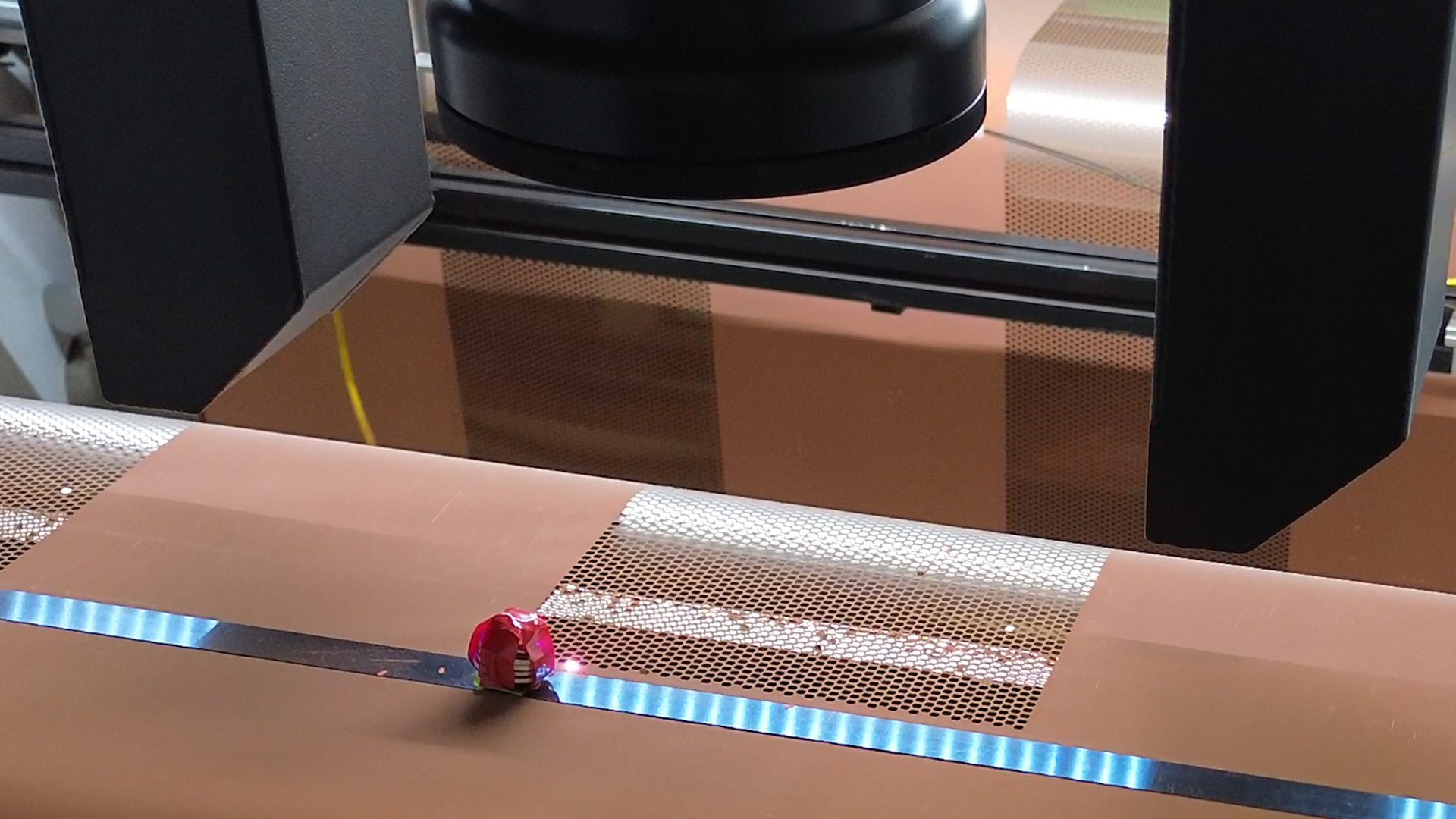 Foil web being laser processed on a conveyor
