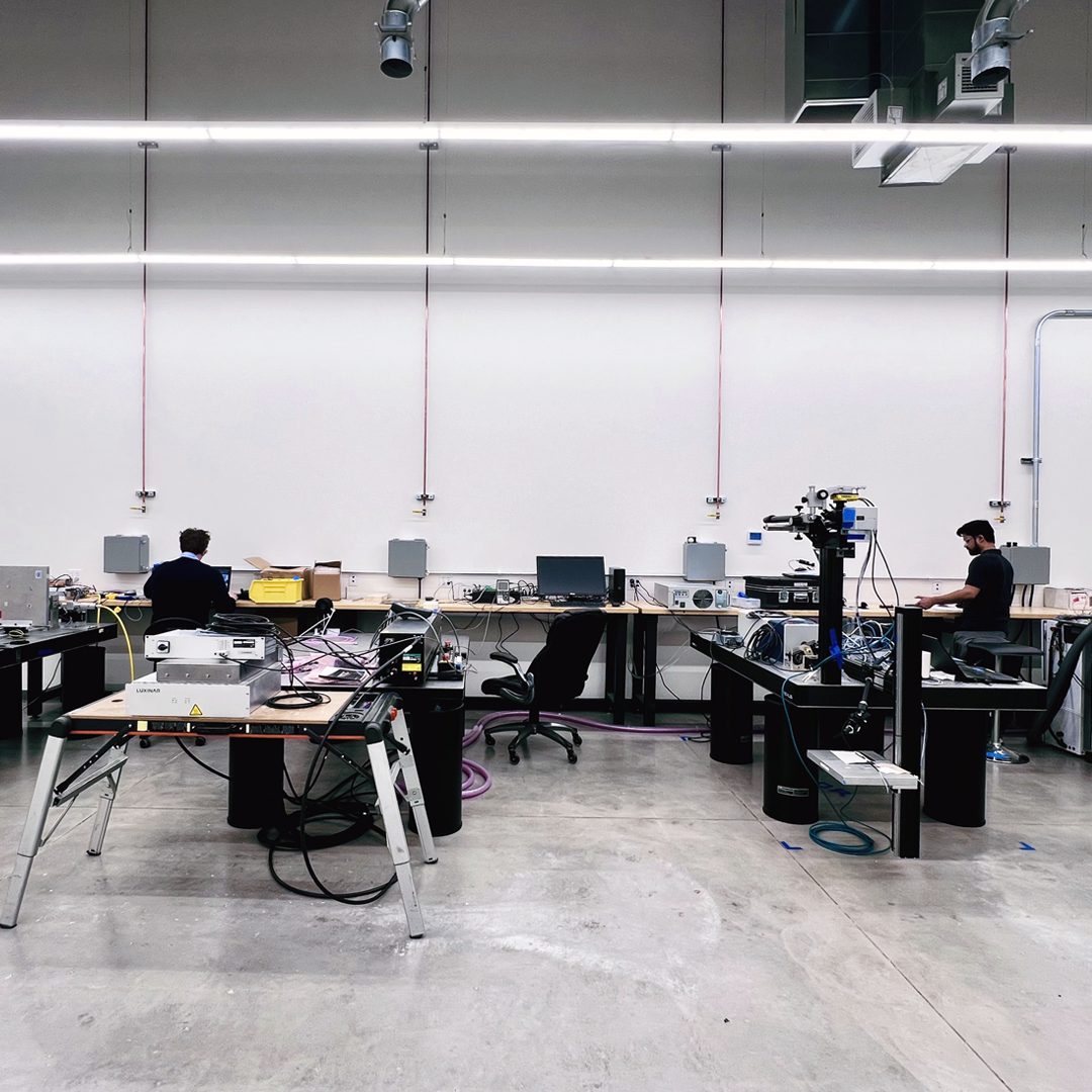 PhotonX lab with engineers at workstations and laser equipment