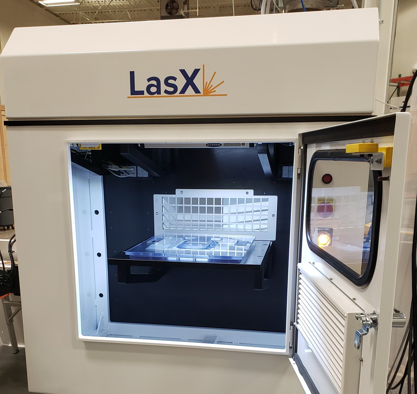 ExactCore laser workstation with its enclosure door open on the fixed bed
